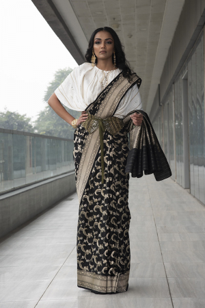 black pure katan silk saree. paired with ivory embroidered cowl top with embroidered velvet tie-knot belt