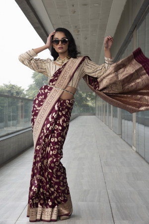 wine pure katan saree with ivory gold sequenced georgette blouse and embroidered belt.