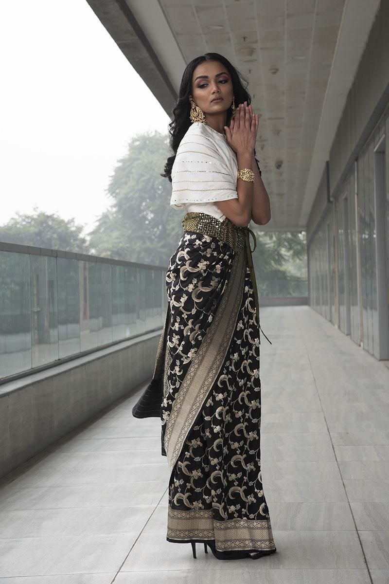 black pure katan silk saree. paired with ivory embroidered cowl top with embroidered velvet tie-knot belt