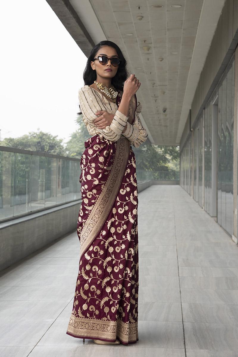 wine pure katan saree with ivory gold sequenced georgette blouse and embroidered belt.