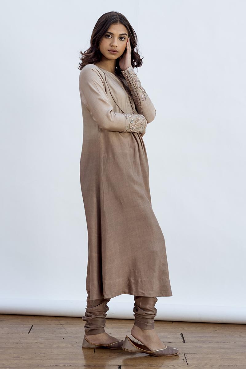 Susan kurta with a round yoke and emrboidery on sleeves and dupatta. features a churidaar  style pant.